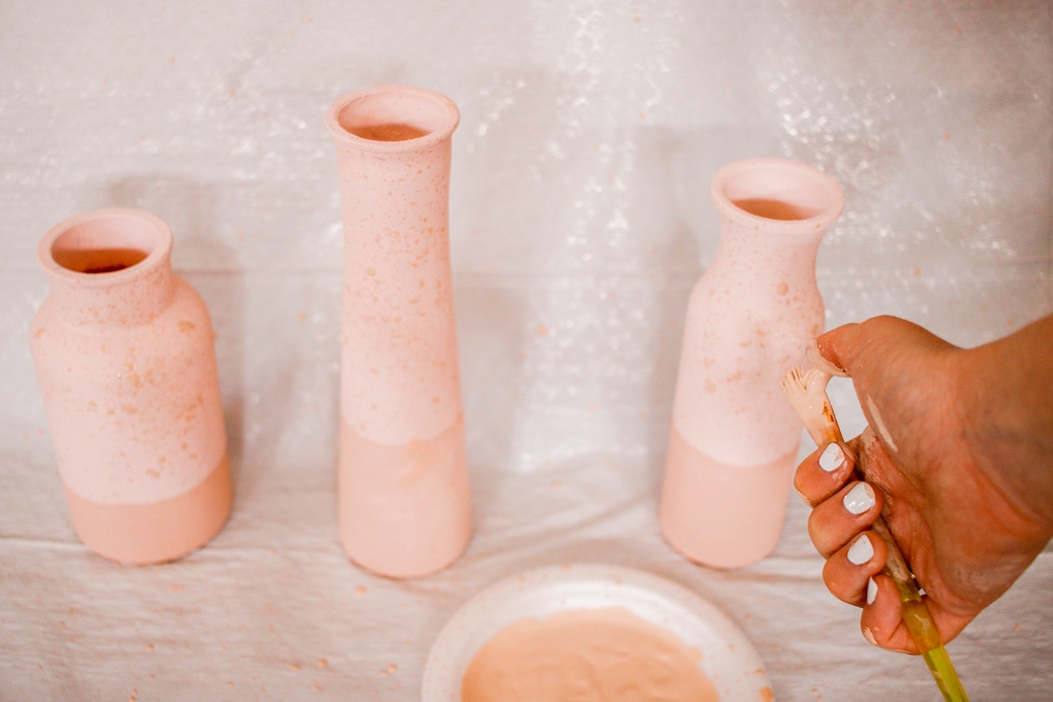 Splatter watered down paint onto vases