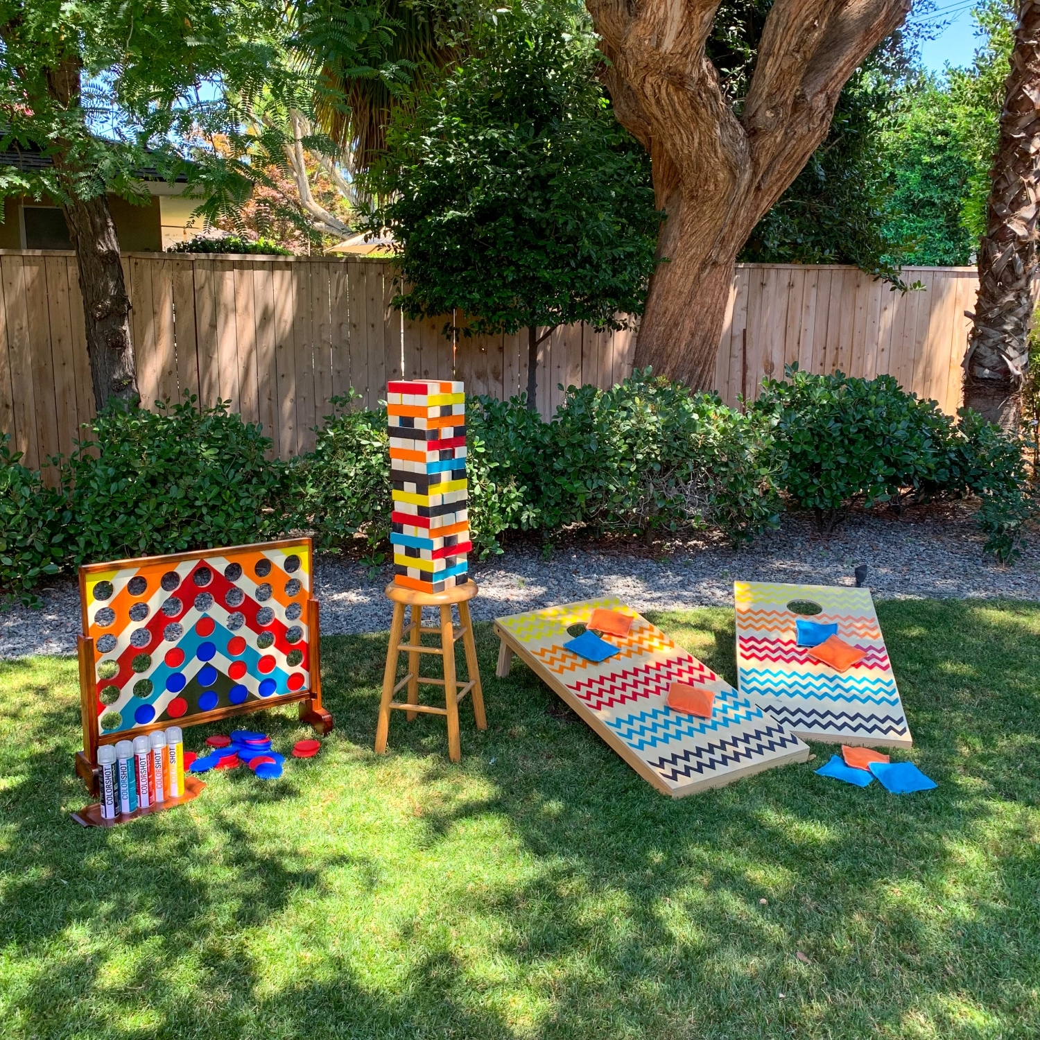 Connect Four, Jenga, and Corn Hole backyard games with COLORSHOT