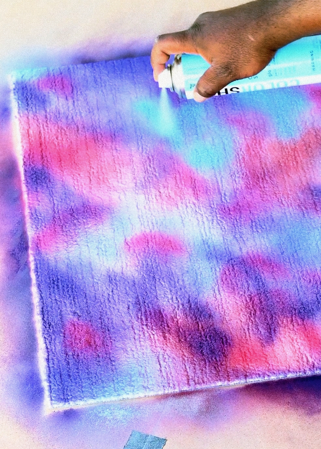 Spray paint rug with blue, pink, and purple paints