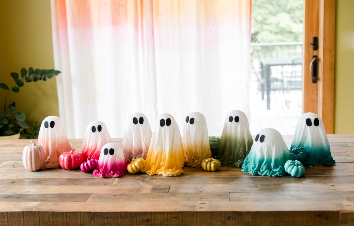 Spray painted cheesecloth ghosts and pumpkins