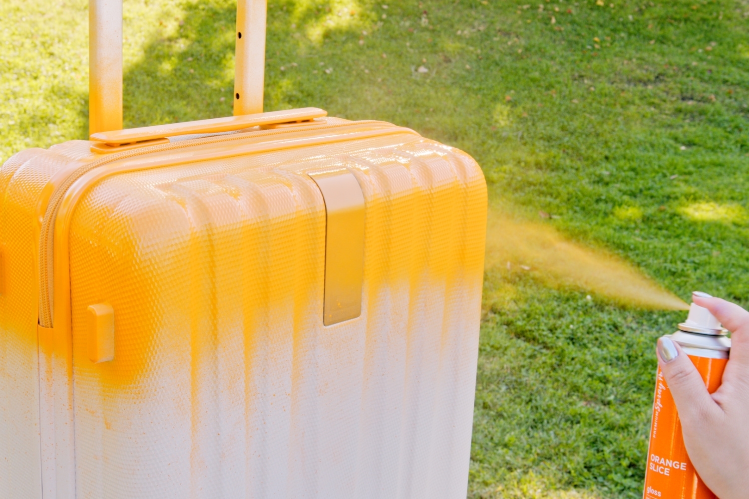 Apply spray paint to the suitcase