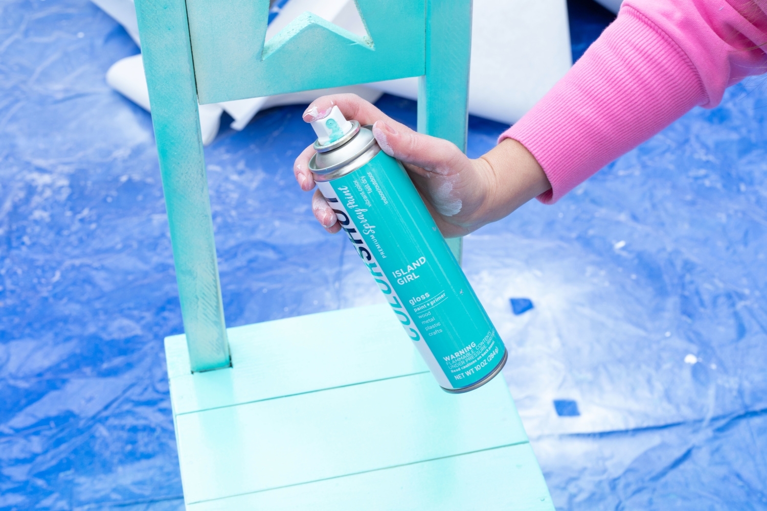 Apply spray paint to she shed furniture